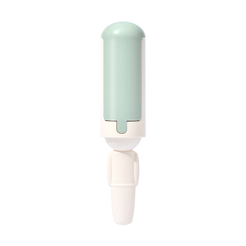 White fabric hair-removal brush with pale mint housing.