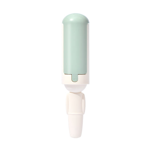 White fabric hair-removal brush with pale mint housing.